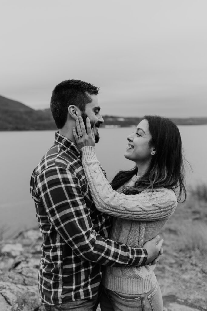 Couple smiling at each other during engagement photography session.
