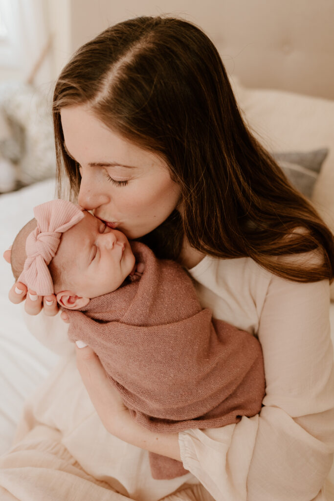 mom kissing newborn baby photographed by a hudson valley newborn photographer