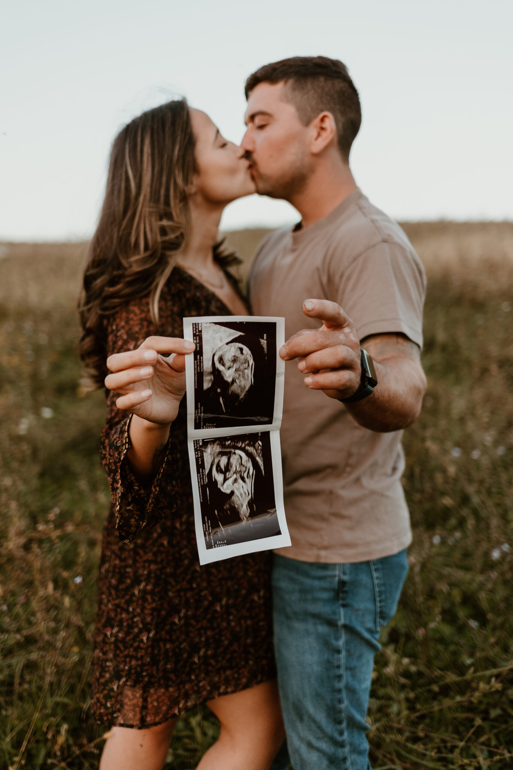 pregnant couple holding ultrasound photo