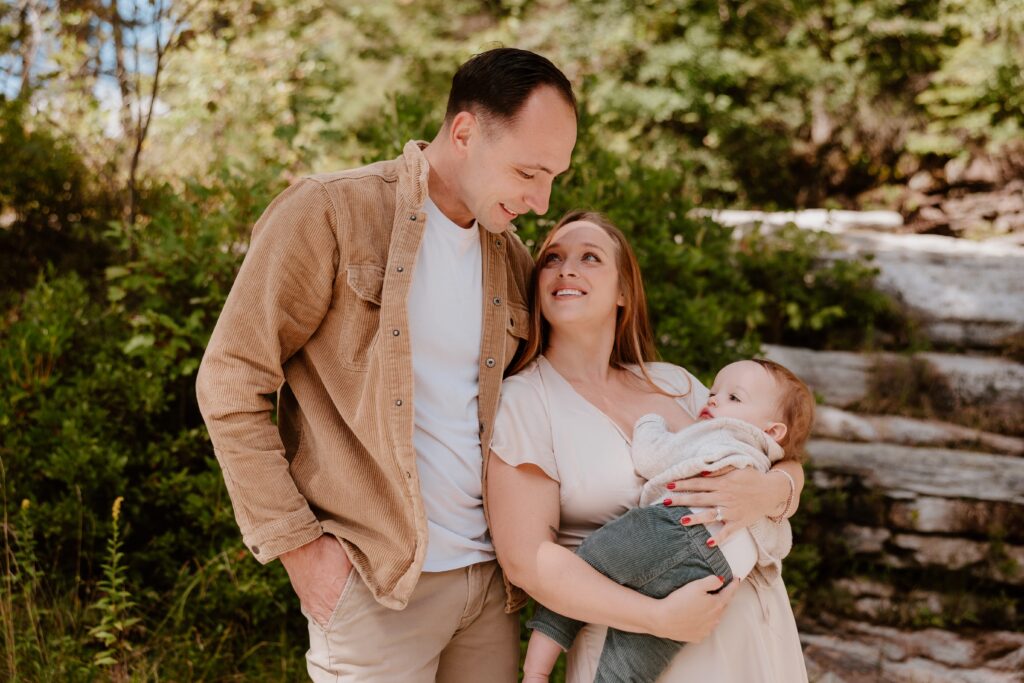 Family of four enjoying a warm moment in the woods, captured by a Hudson Valley family photographer.