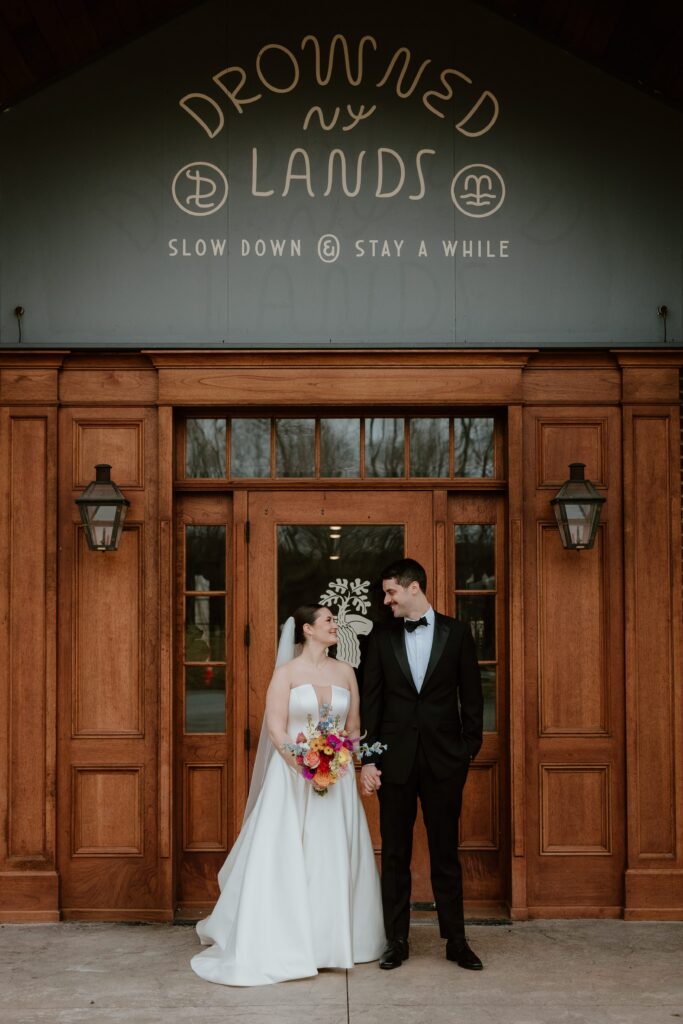 Drowned Lands Brewery wedding venue exterior in Warwick New York with couple standing at entrance