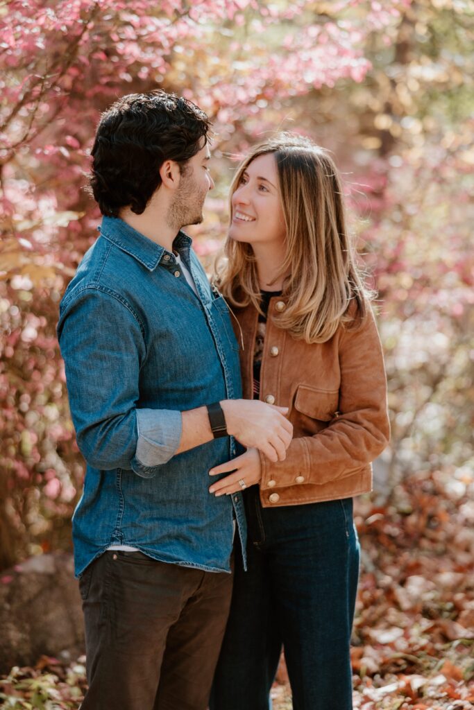 Couple surrounded by colorful fall foliage at Rockefeller State Park Preserve.